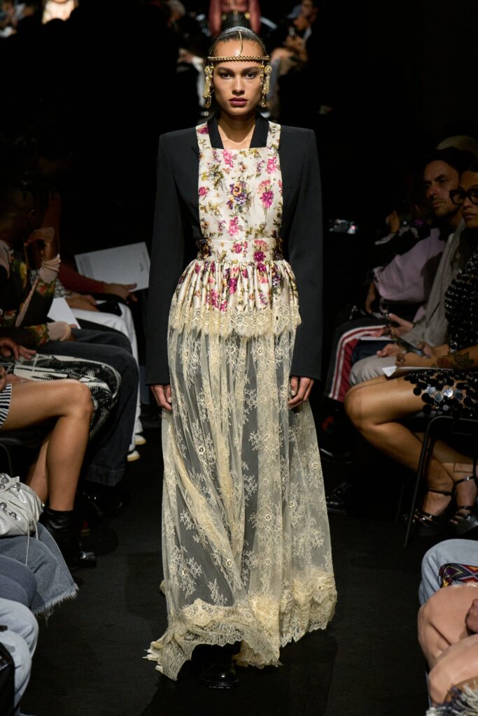 A fitted black and cream layered dress with long sleeves and a V-neckline.