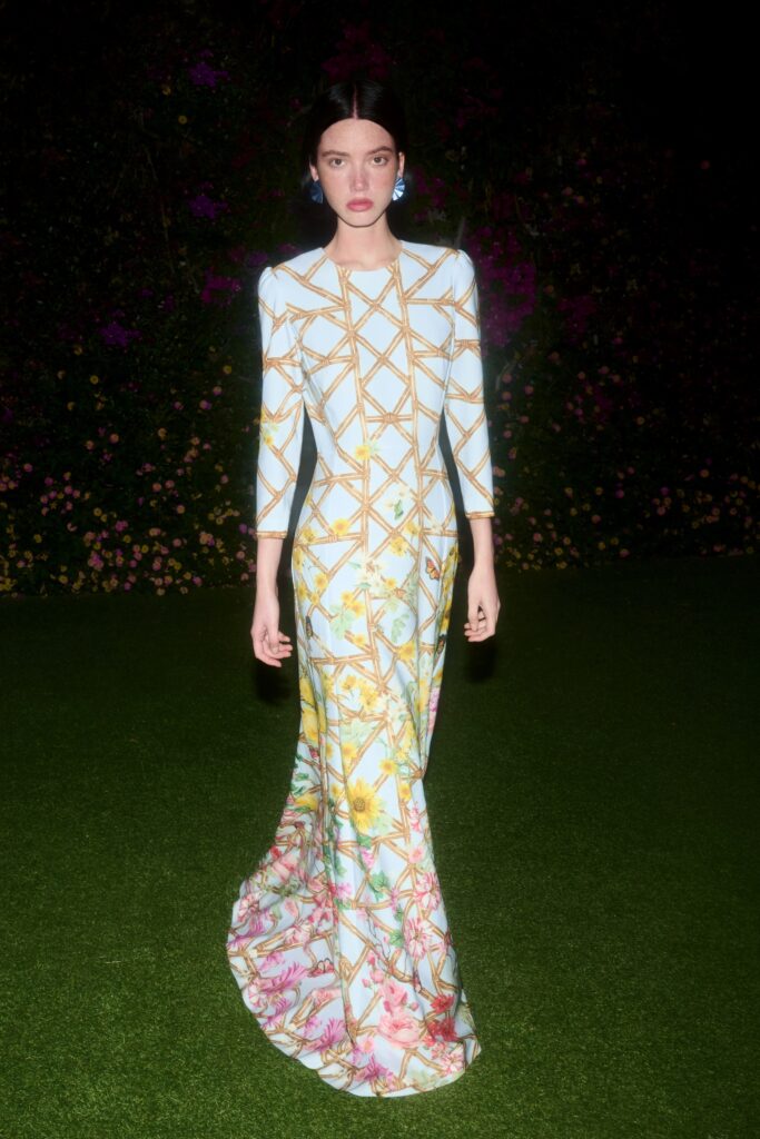 A fitted multicolor silk gown with long sleeves and a flared silhouette.