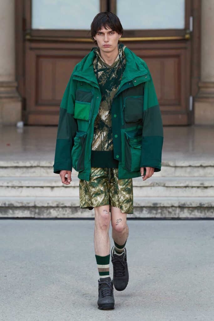 A relaxed green jacket paired with printed shorts, perfect for a casual yet stylish look.