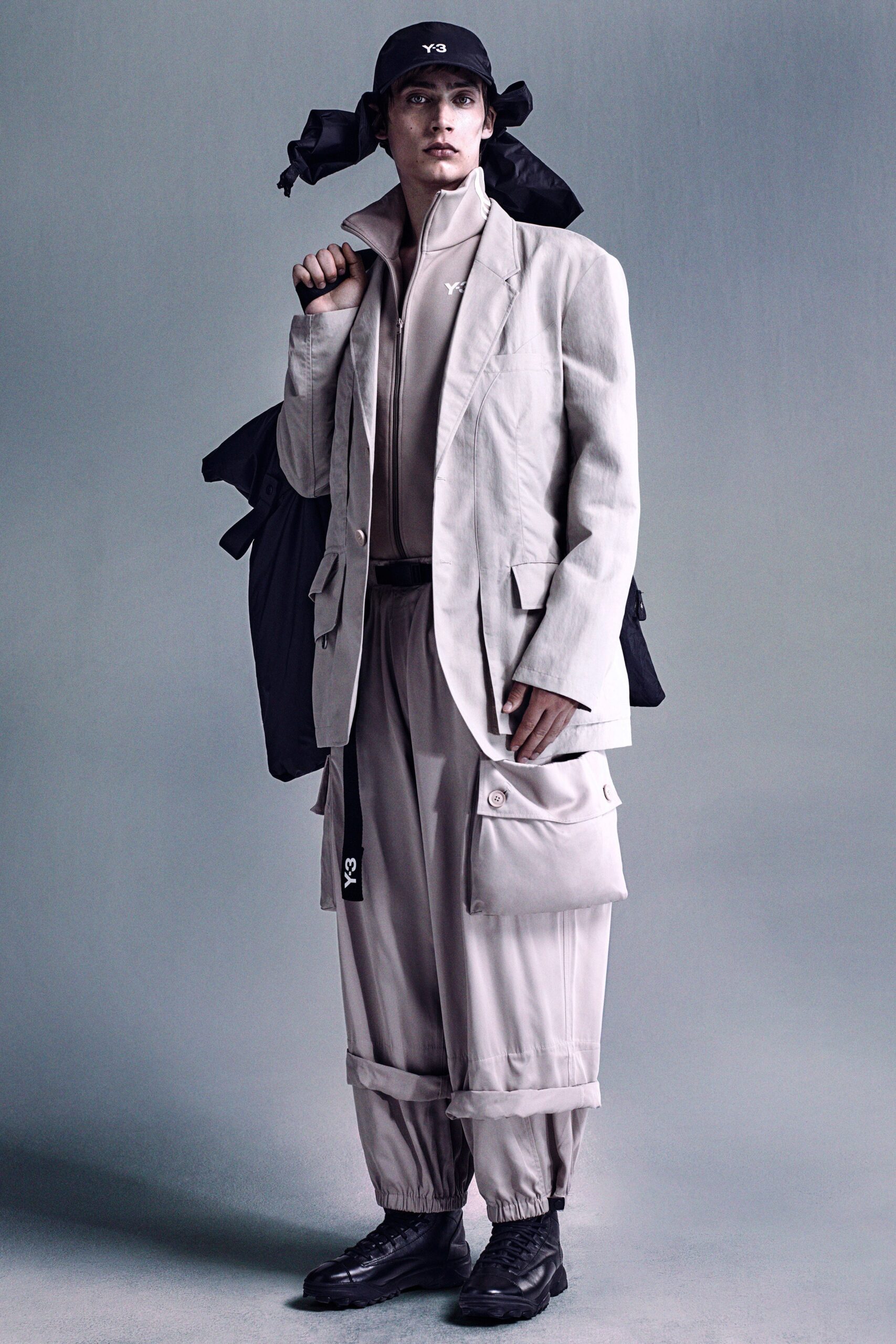 A relaxed beige jacket with long sleeves and collared design paired with cargo pants.