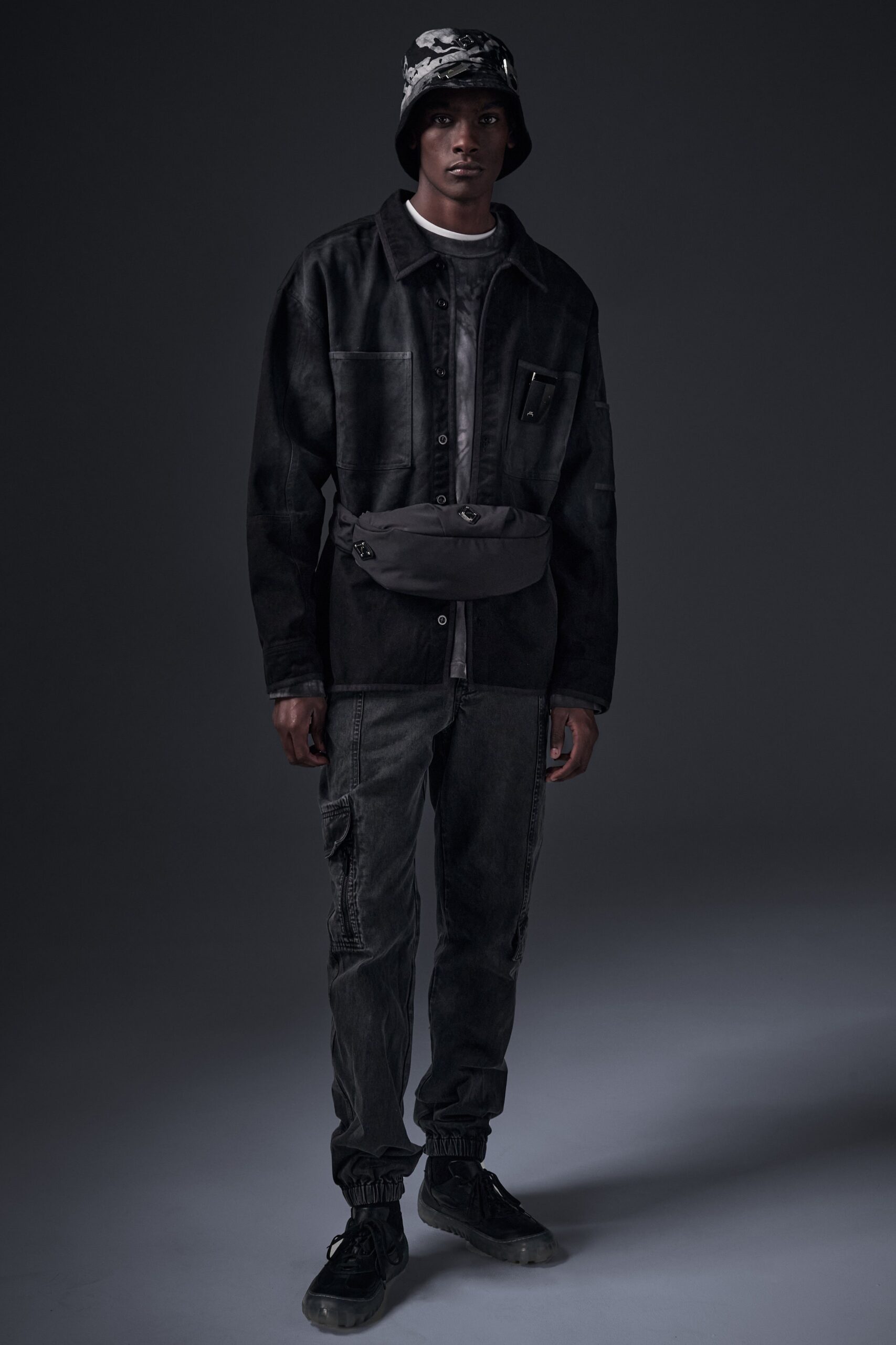 A relaxed black denim jacket paired with matching pants, featuring a buttoned design.