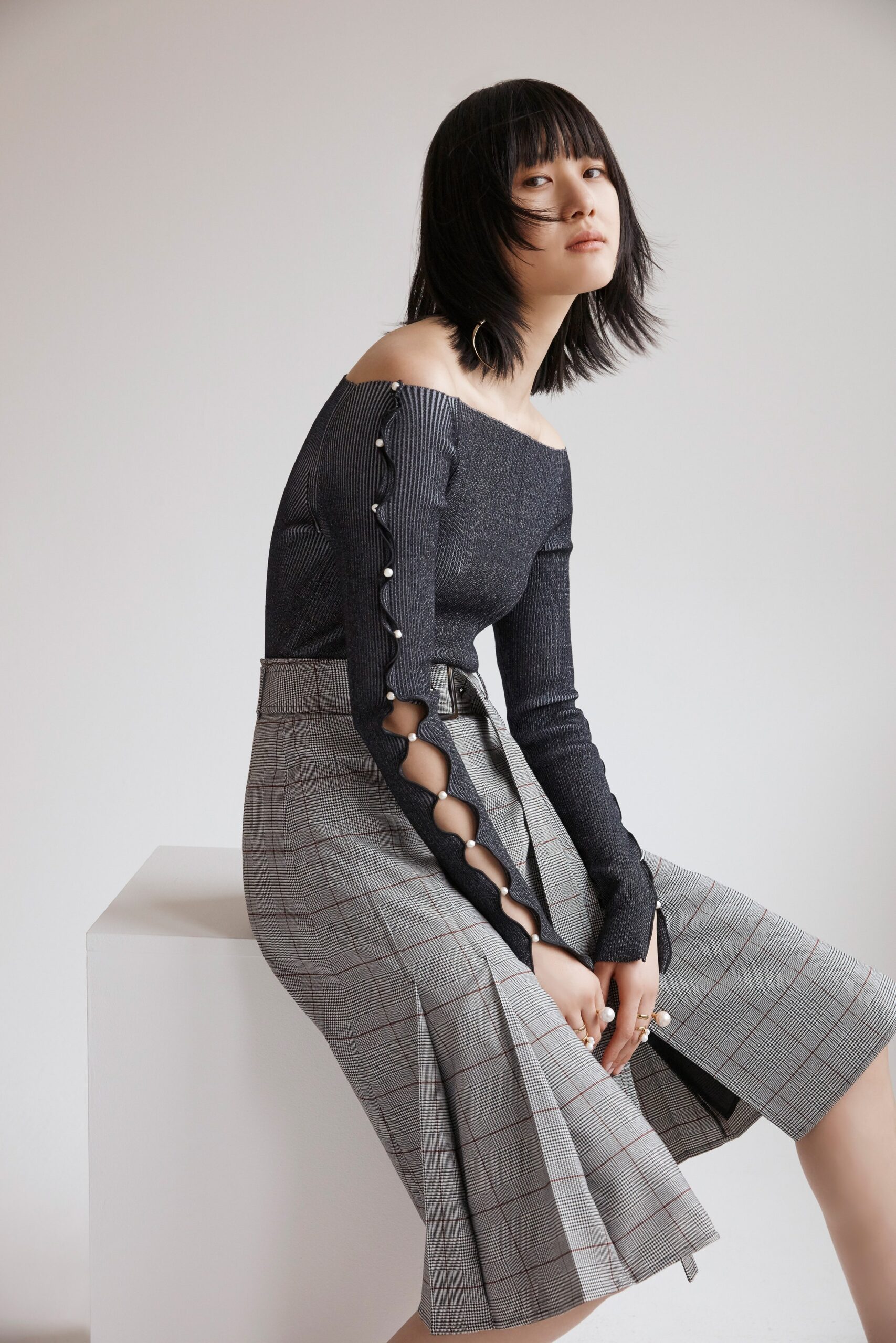 black fitted off-shoulder top and gray skirt