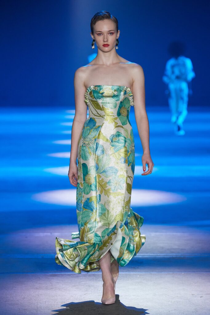 A fitted blue and green silk strapless dress with a flared silhouette.
