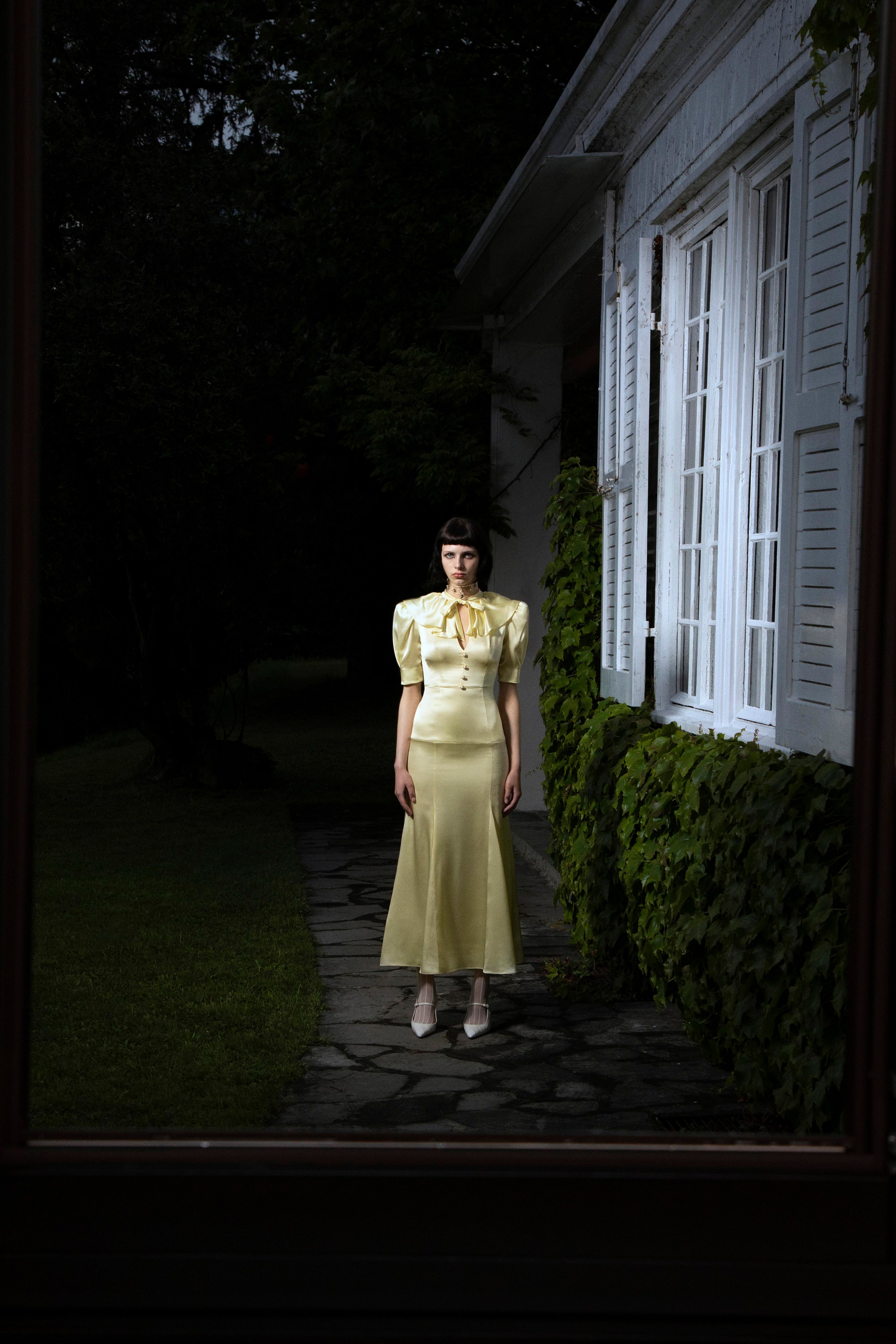 A fitted yellow dress with short sleeves, a V-neckline, and a tiered design.