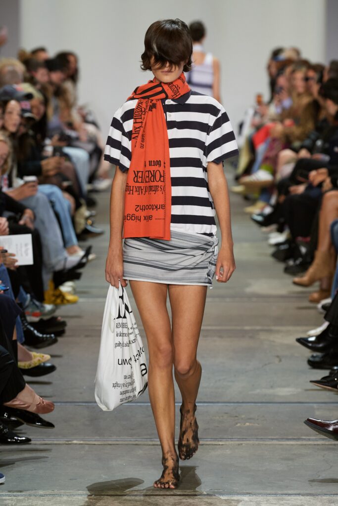 A fitted striped top with a collared neckline paired with an asymmetric skirt.