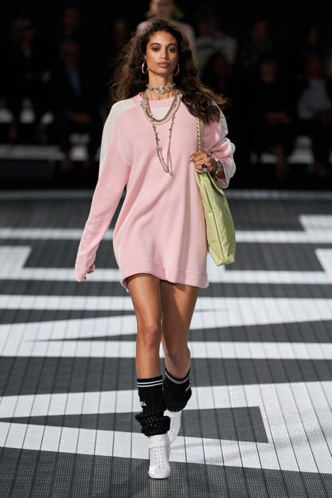 A relaxed pink cotton dress with long sleeves and a mini silhouette.