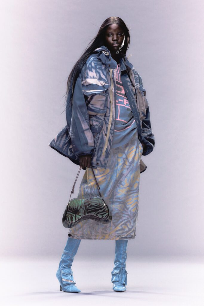 A relaxed blue denim jacket paired with a multicolor printed skirt.