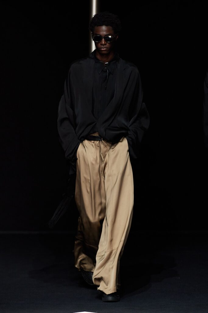 black relaxed shirt and beige wide-leg pants