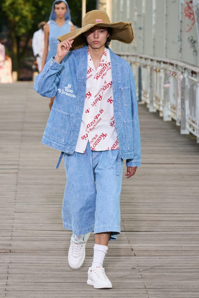 A relaxed blue denim jacket paired with wide-leg pants and a collared shirt.