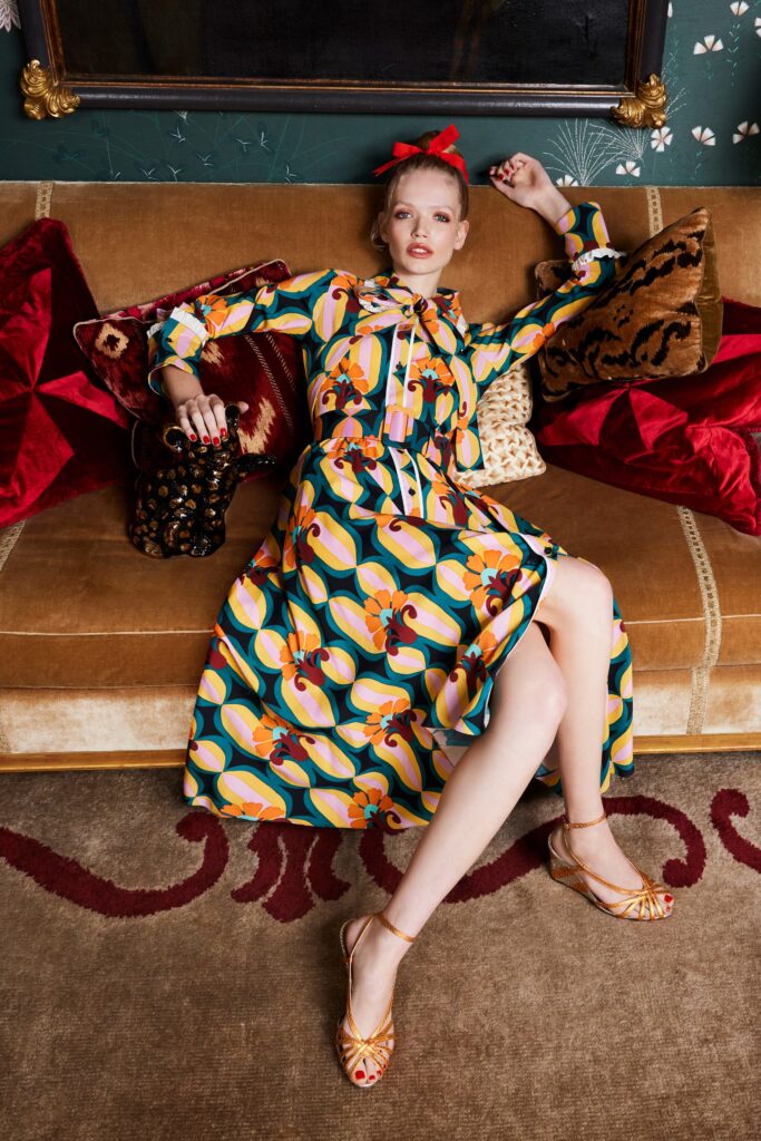 A relaxed multicolor printed dress with long sleeves and a collared neckline.
