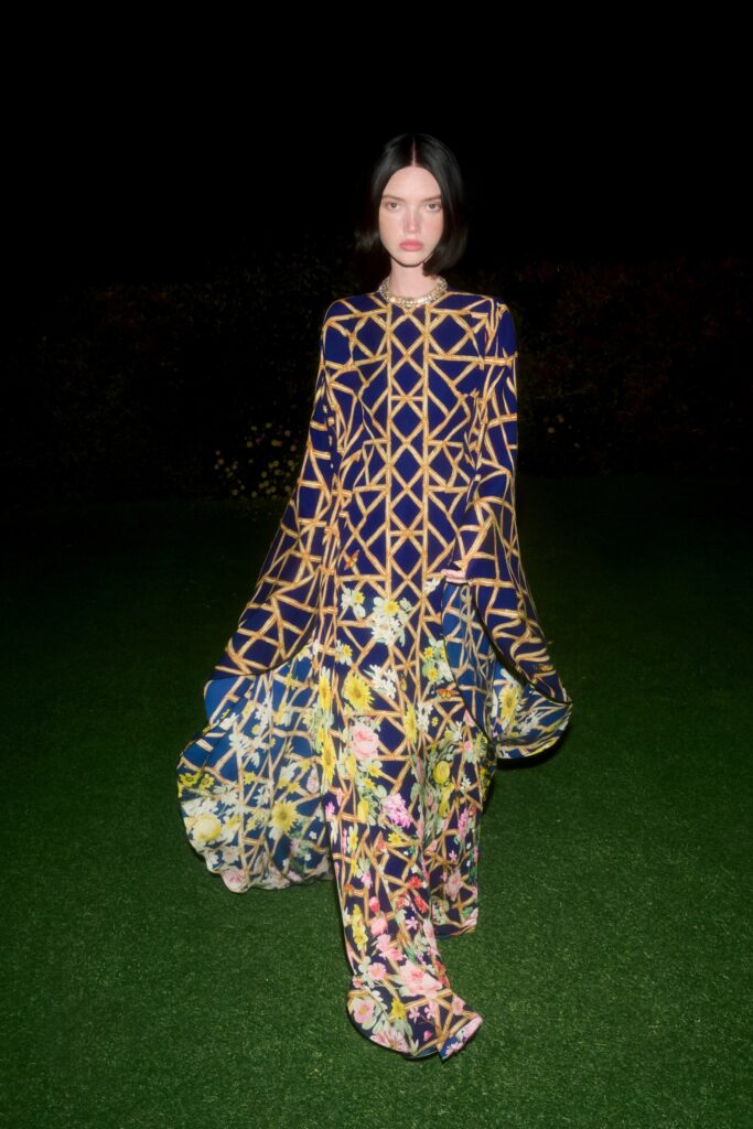 A relaxed blue multicolor printed dress with long sleeves and a collared neckline.
