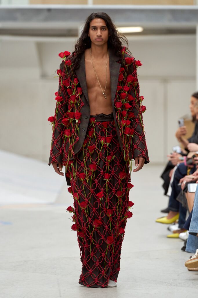 A relaxed black jacket with red floral details and a flared skirt, featuring a collared long-sleeve design.