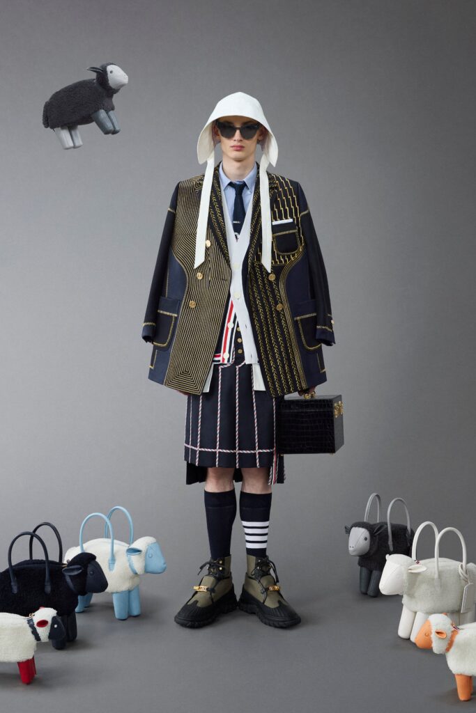 An oversized black and white jacket with long sleeves and a collared design, paired with a high-waisted skirt.