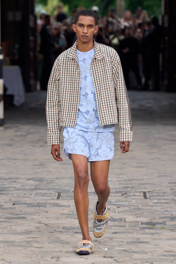 A relaxed-fit beige checked jacket paired with printed blue shorts, perfect for casual outings.