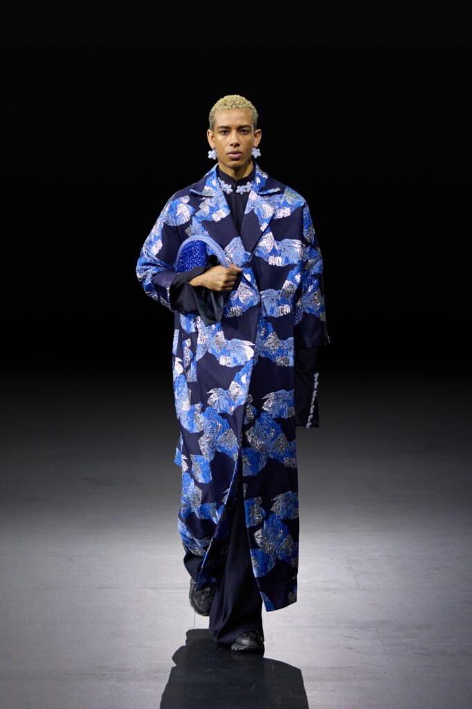 An oversized blue silk coat featuring a vibrant floral print, perfect for a statement look.