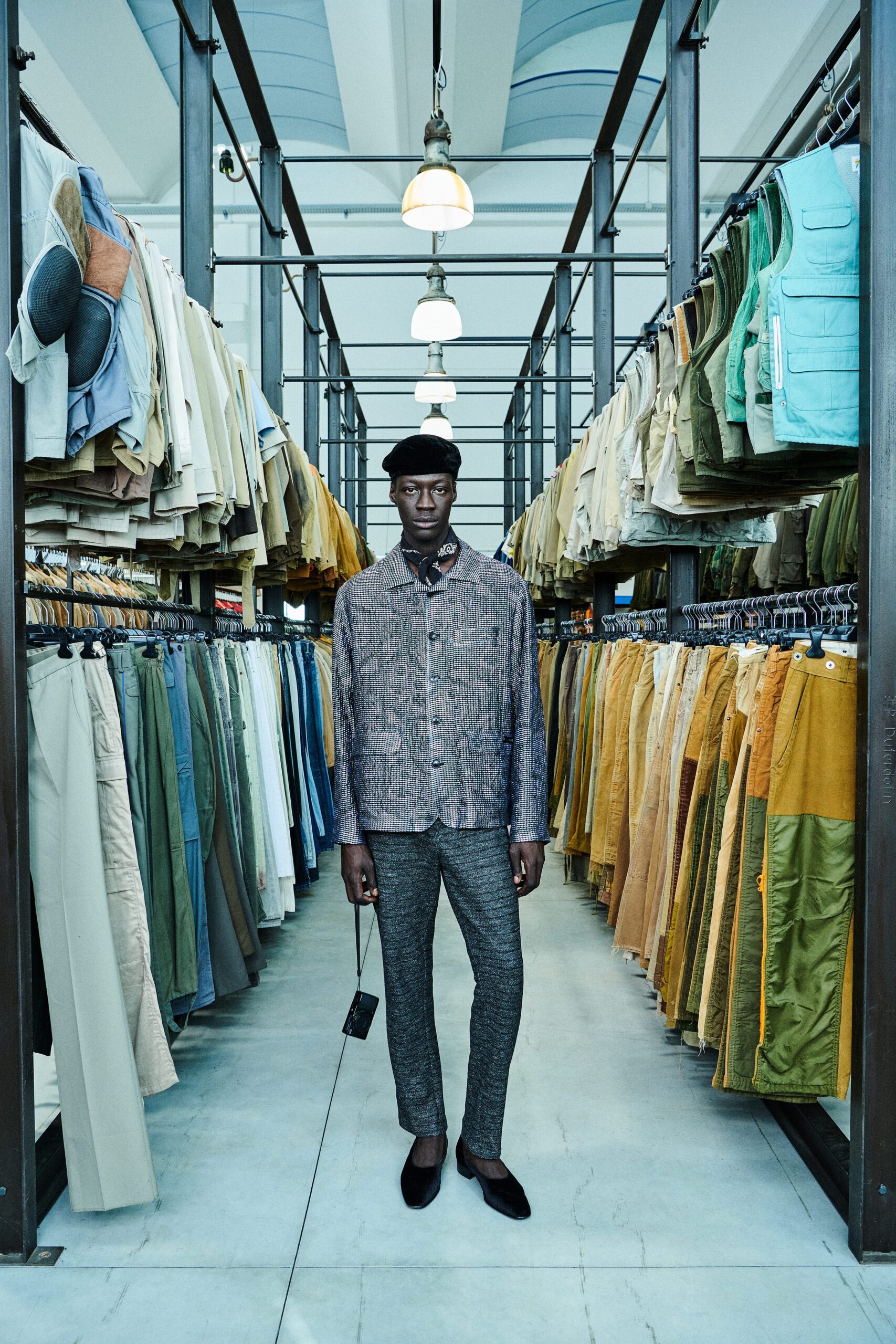 A fitted gray checked jacket with long sleeves and collared design paired with fitted blue pants.