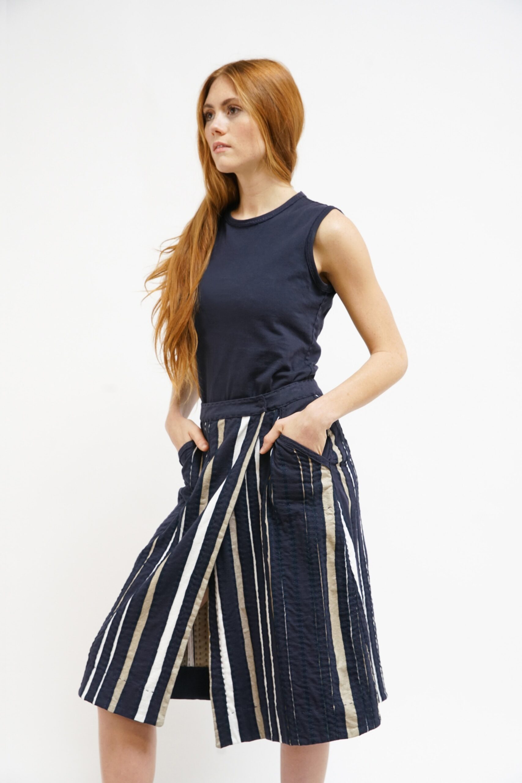 navy sleeveless top with pleated skirt