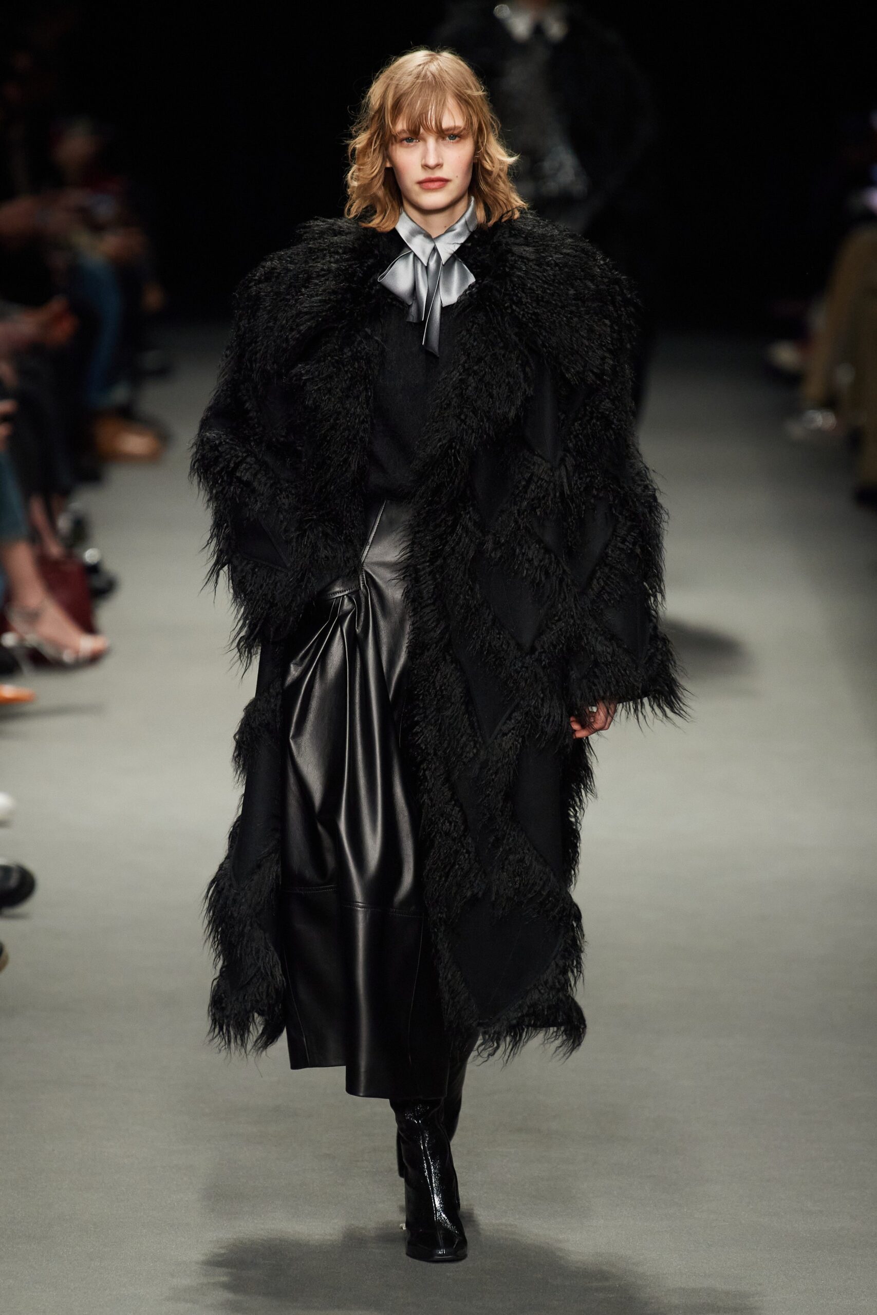 black fur oversized coat and fitted leather dress