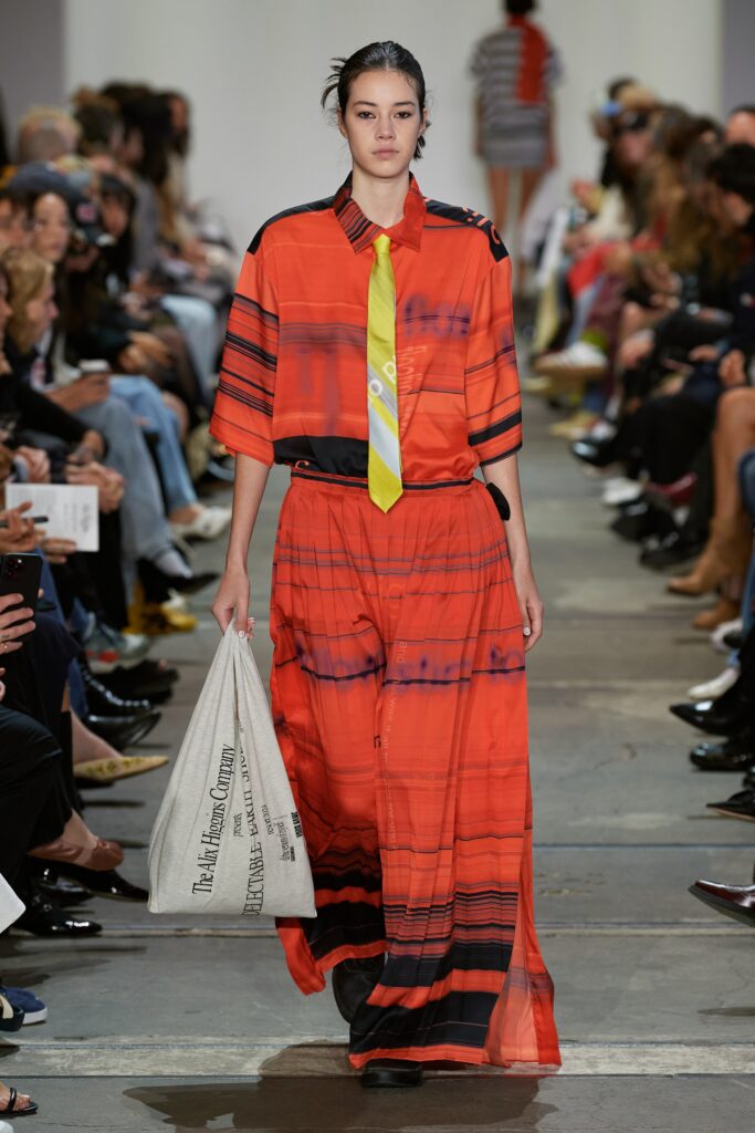 A relaxed red dress with short sleeves, a collared neckline, and a tiered striped design.
