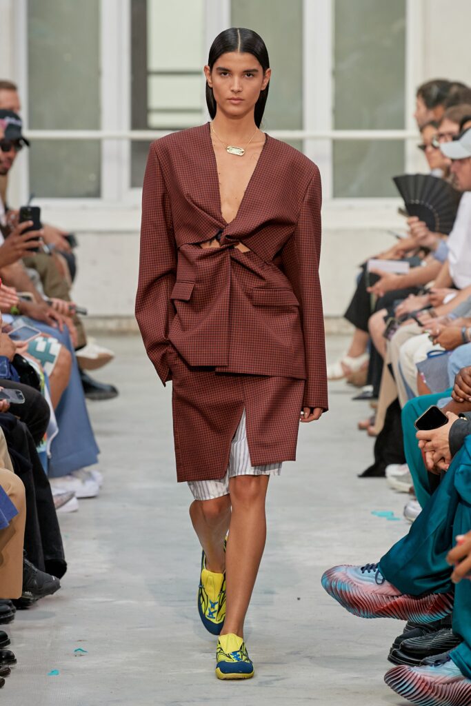 A relaxed brown cotton blazer with an asymmetric design paired with a matching skirt.