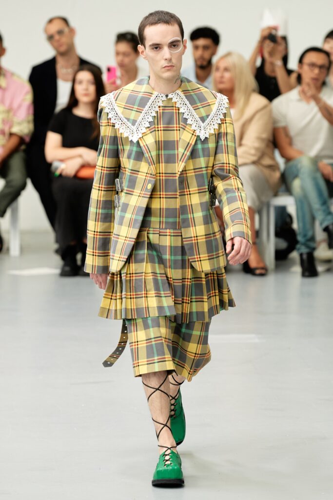 A fitted checked suit with a collared long-sleeve jacket and matching skirt.