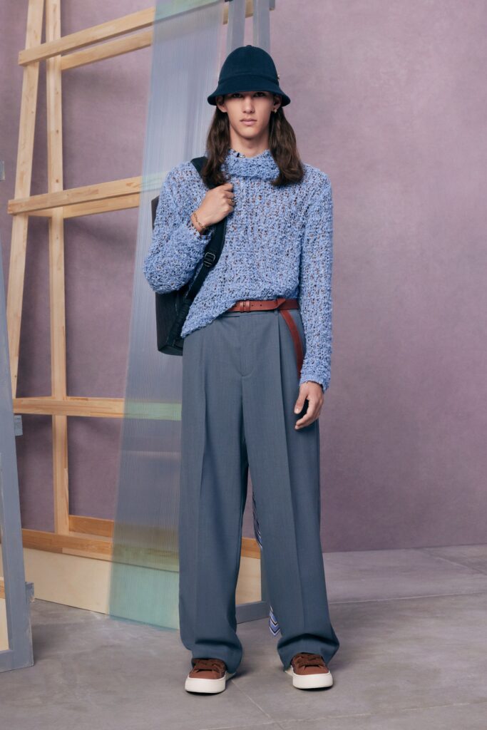 An oversized blue sweater paired with high-waisted gray trousers for a relaxed yet stylish look.