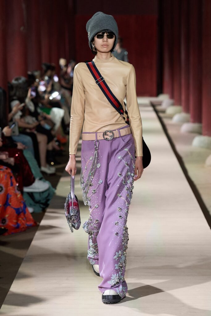 beige silk fitted top and purple embroidered pants