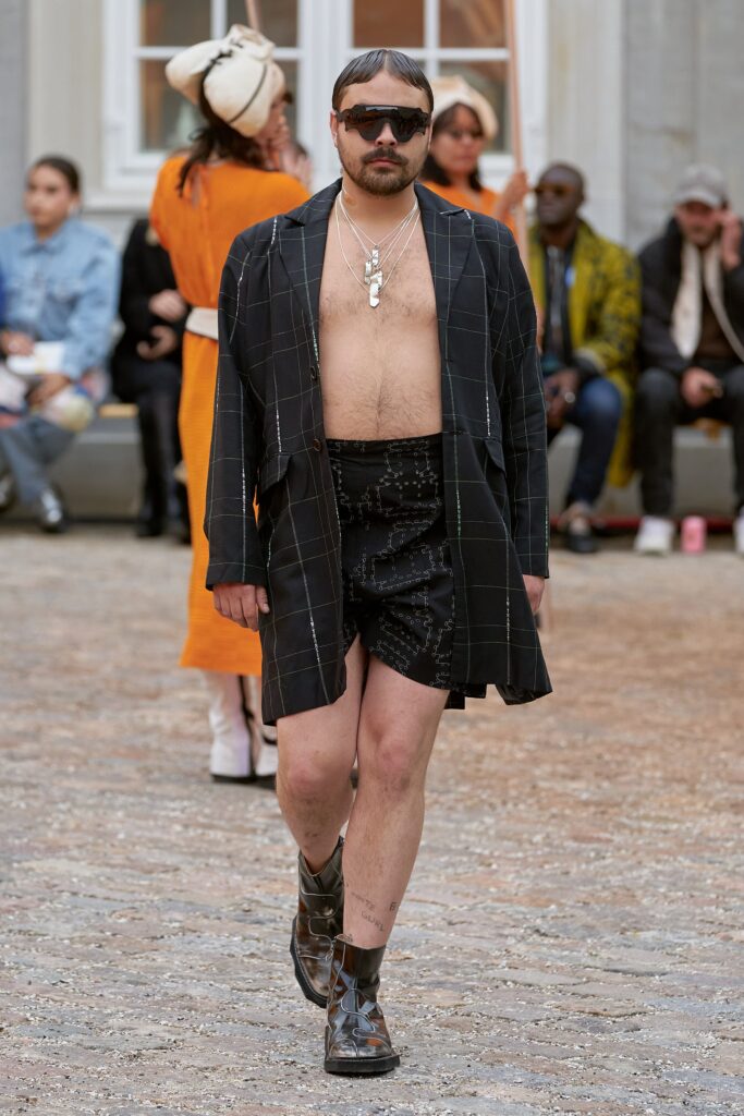 A relaxed black checked jacket with long sleeves paired with a matching skirt.