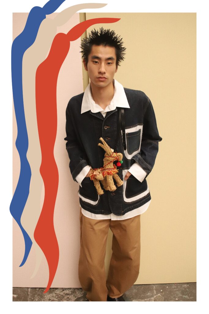 An oversized blue denim jacket paired with beige cotton pants for a relaxed look.