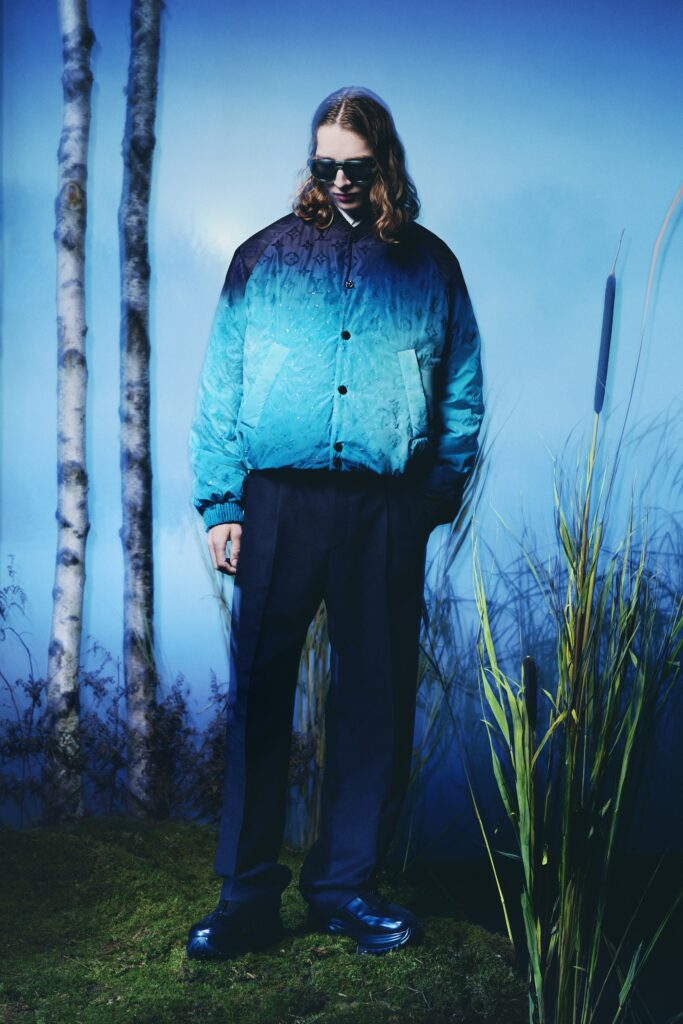 A relaxed fit blue and black color-blocked jacket paired with tailored pants.