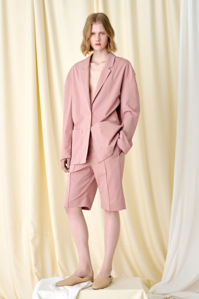 A relaxed pink cotton jacket with long sleeves and collared design paired with matching shorts.