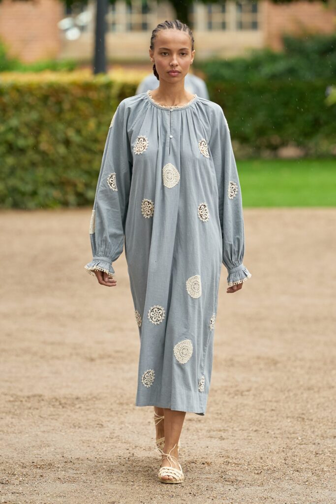 A relaxed gray cotton dress with long sleeves and embroidered details.