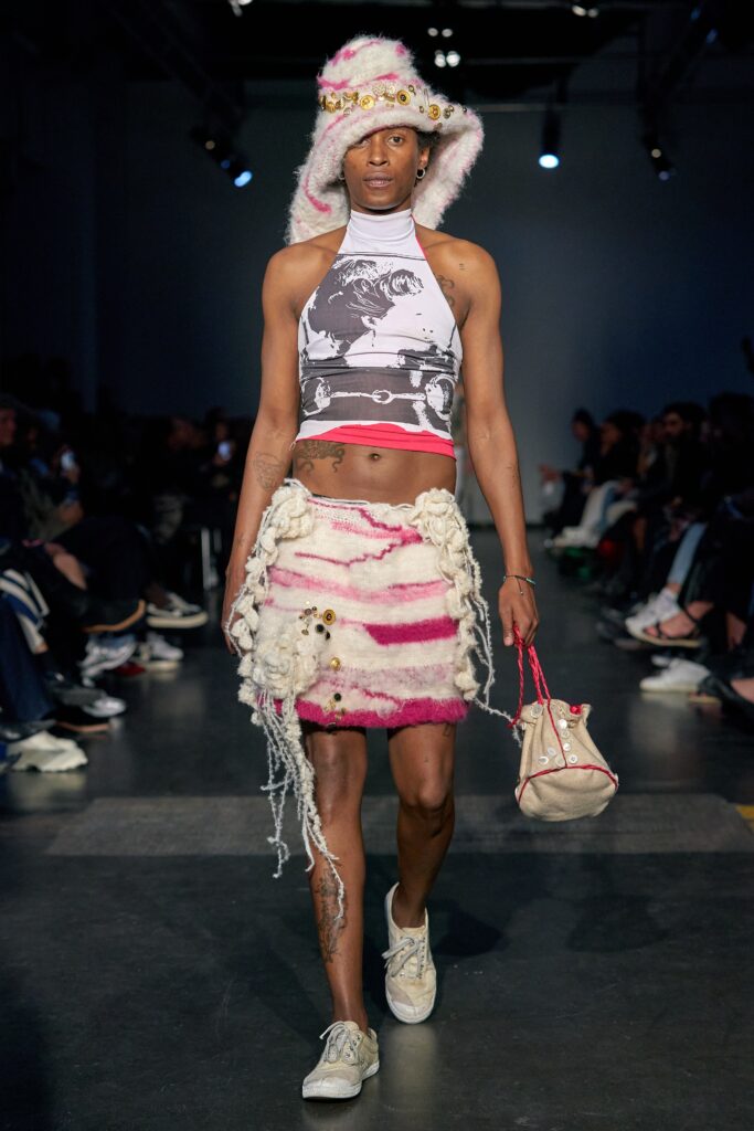 A fitted sleeveless striped crop top paired with a fringed skirt in white and pink.