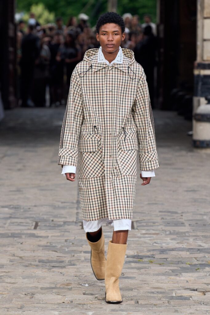 A relaxed beige checked coat with long sleeves and a collared neckline.