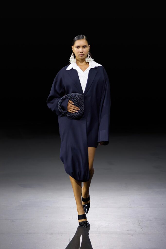 An oversized navy dress with a collared design and a unique silhouette.