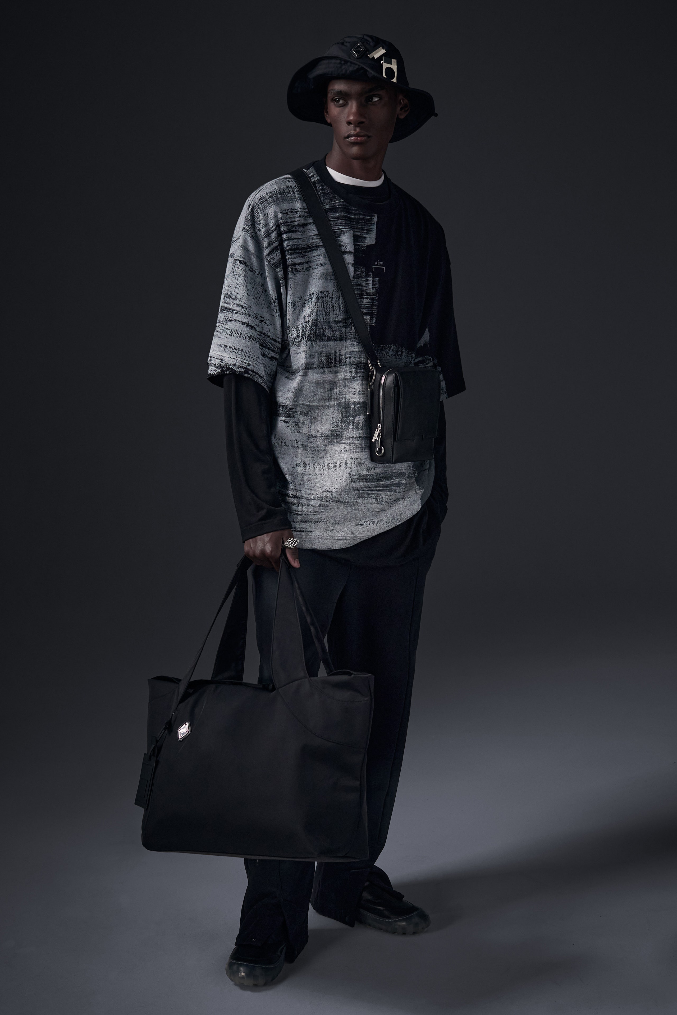 A relaxed-fit black and gray printed shirt paired with comfortable pants.