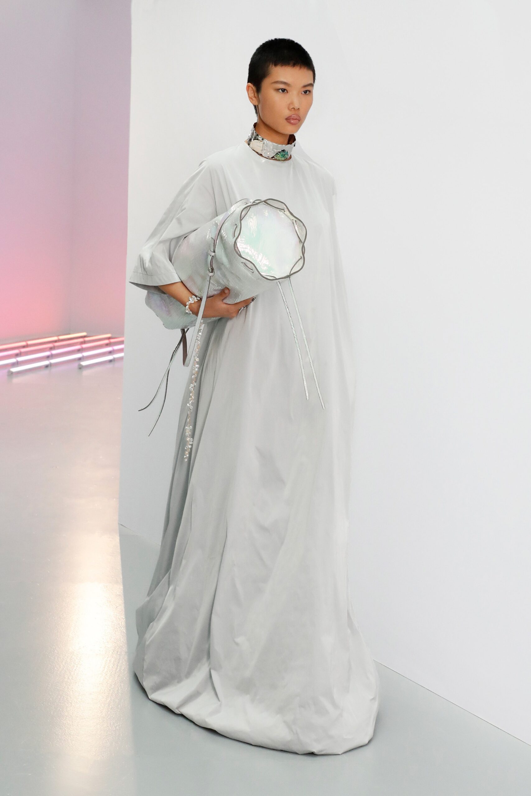 gray silk relaxed gown with metallic bag