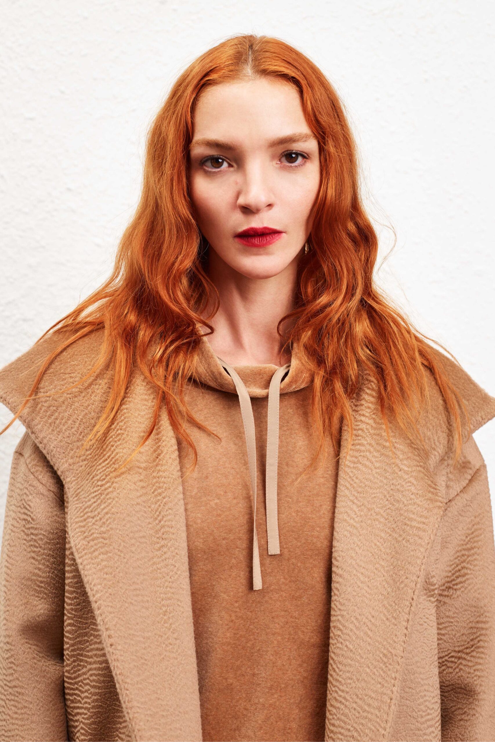 beige wool coat and tan hoodie