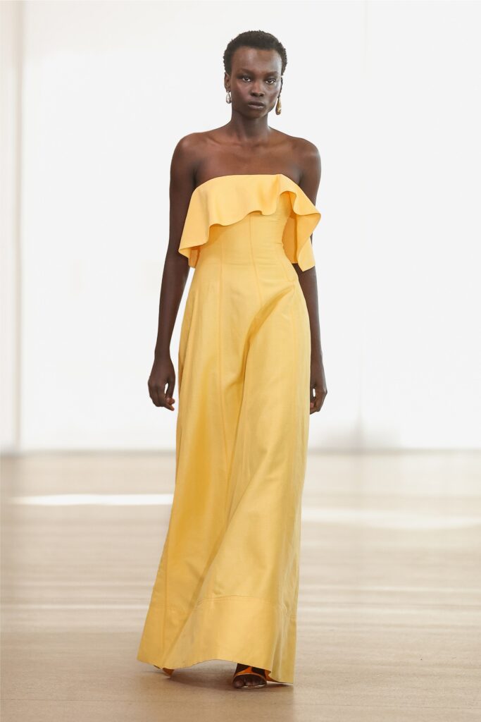A fitted yellow strapless gown featuring a ruffled detail for a stylish look.