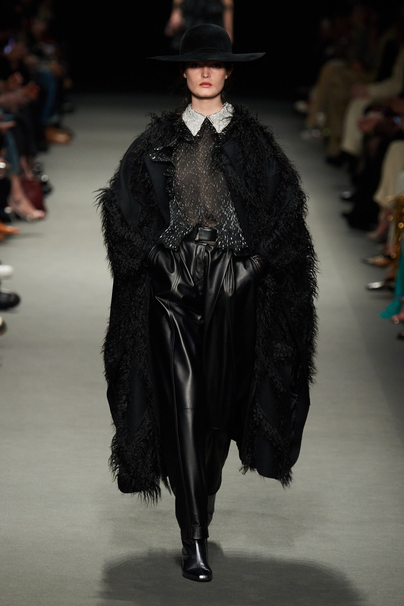 black fur cape and leather pants