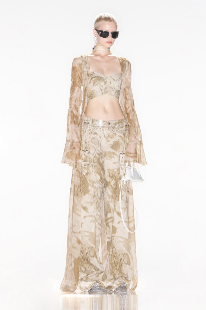 A relaxed beige silk outfit featuring a sleeveless top and printed wide-leg pants.