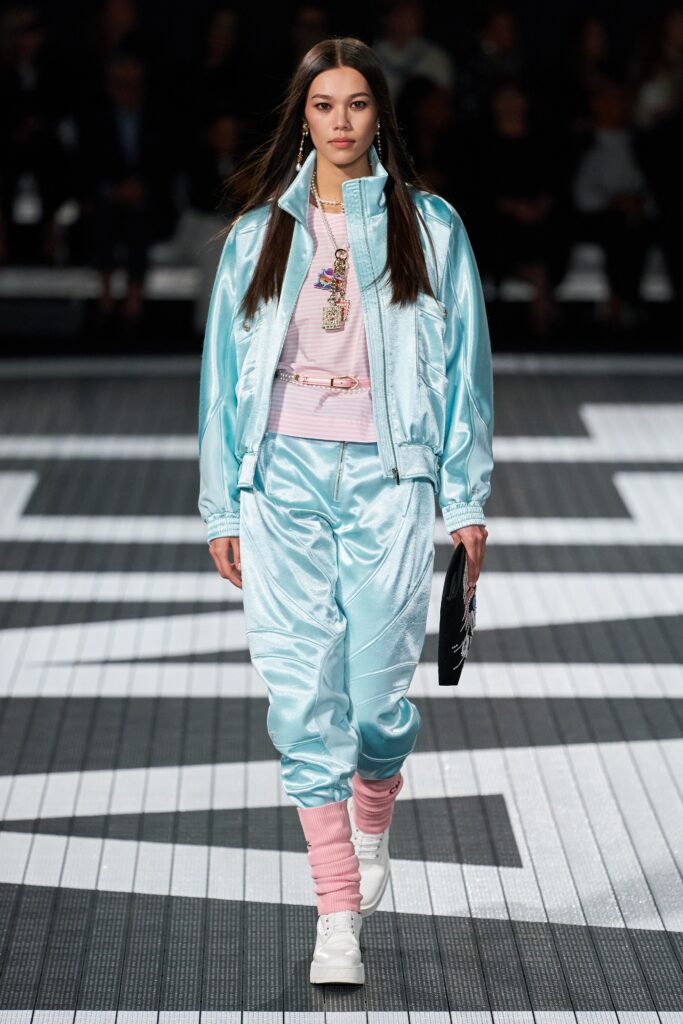 A relaxed blue satin jacket with long sleeves and matching pants, featuring a zippered detail.