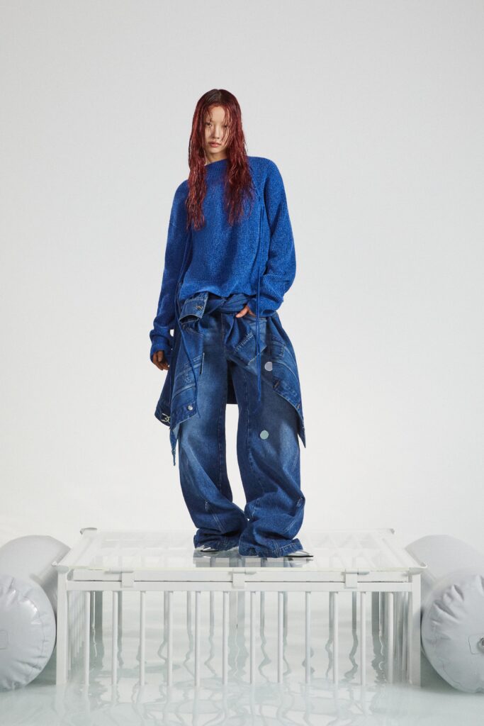 A relaxed blue long-sleeve top paired with wide-leg denim pants for a casual look.