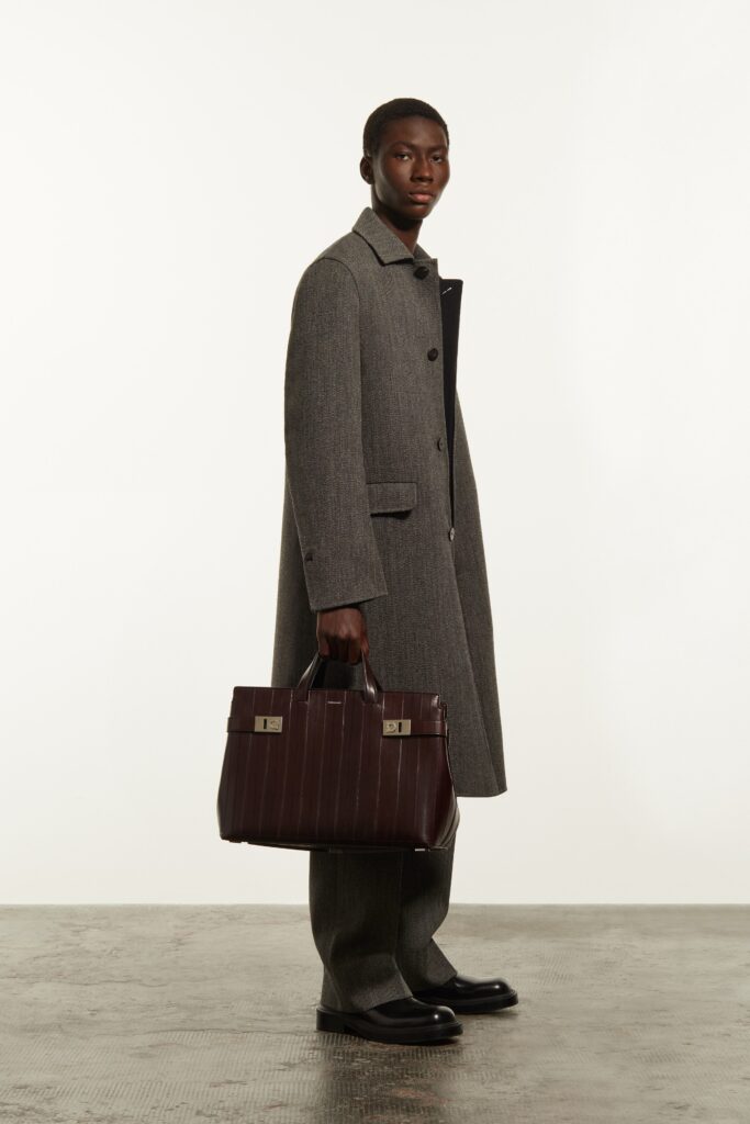 A relaxed gray wool coat with a collared neckline and buttoned detail, paired with matching pants.