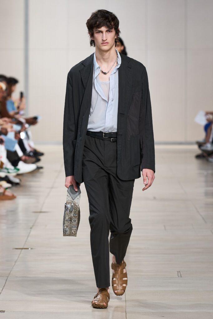 A relaxed black jacket paired with blue pants featuring a collared neckline and straight-leg design.