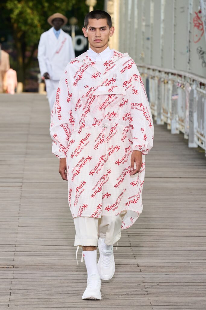 An oversized white coat with long sleeves and a collar, featuring a bold red print.