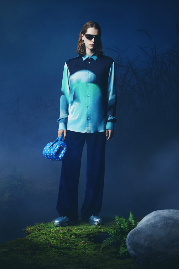 A relaxed blue cotton long-sleeve shirt paired with navy straight-leg pants.