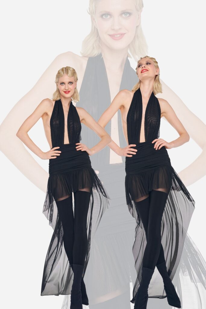 A fitted black silk sleeveless dress with a V-neckline and layered design.