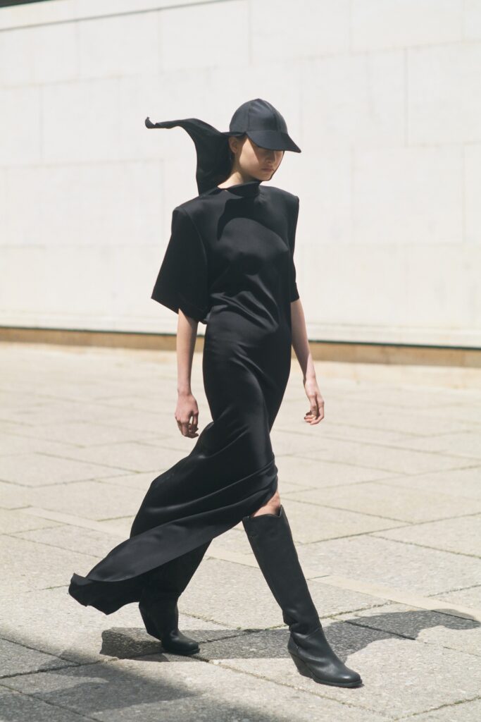 black fitted maxi dress with asymmetric design