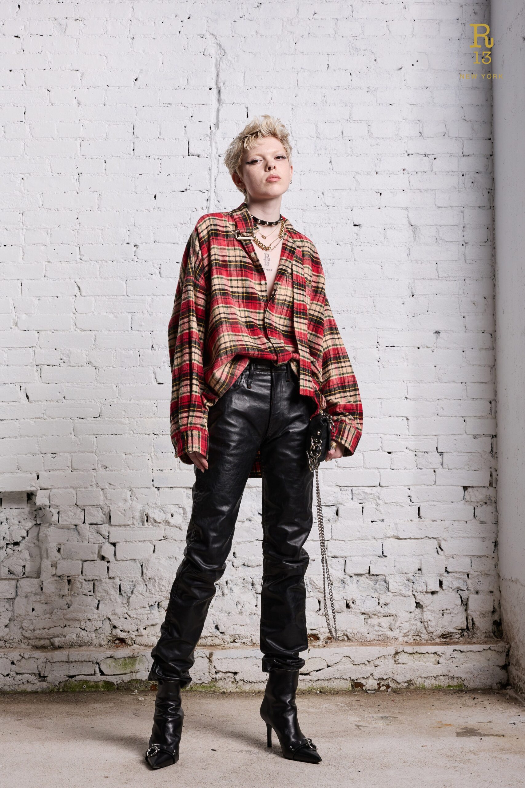 An oversized plaid shirt paired with slim black leather pants for a chic look.